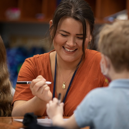 Teacher working with young student