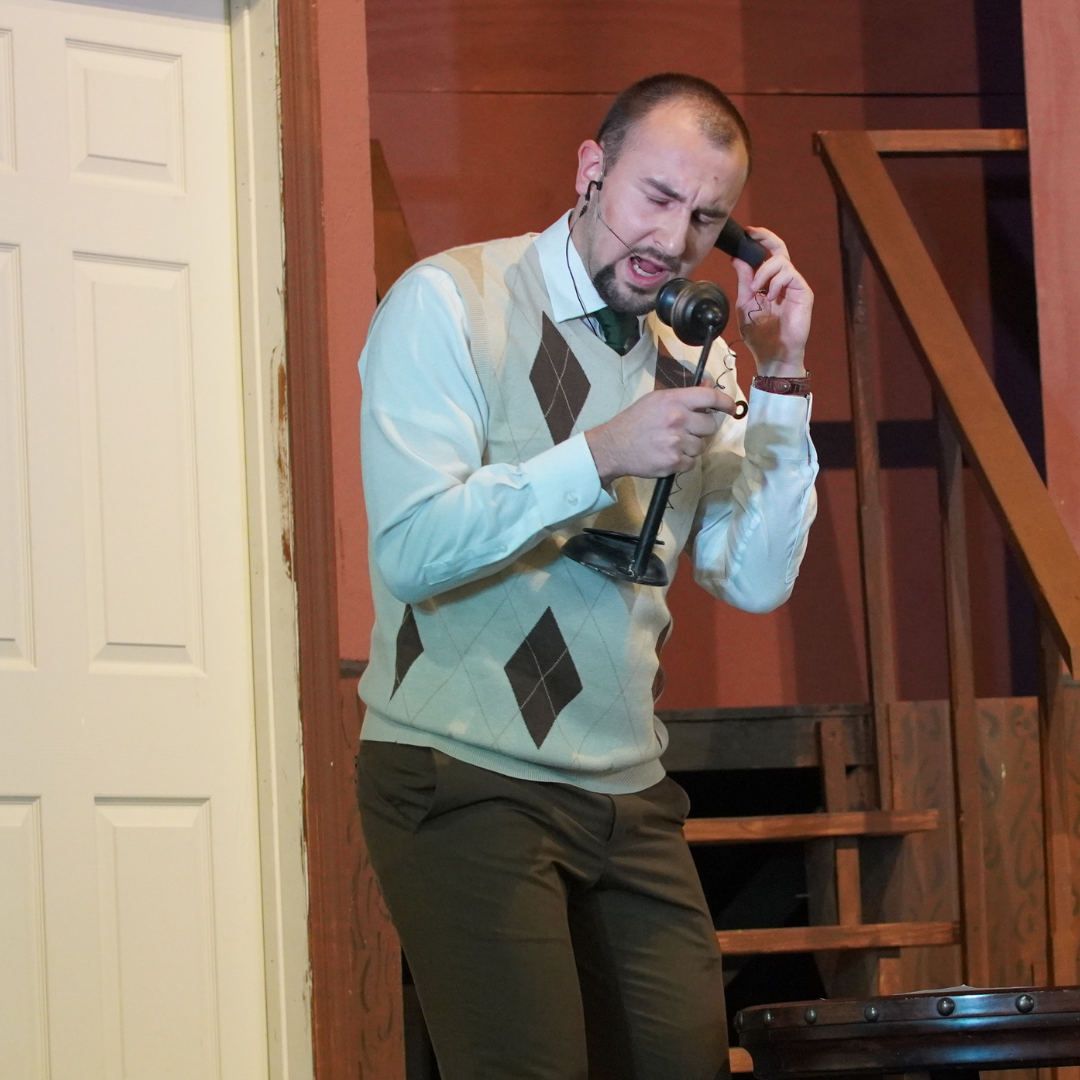 Staff member on stage at faculty play